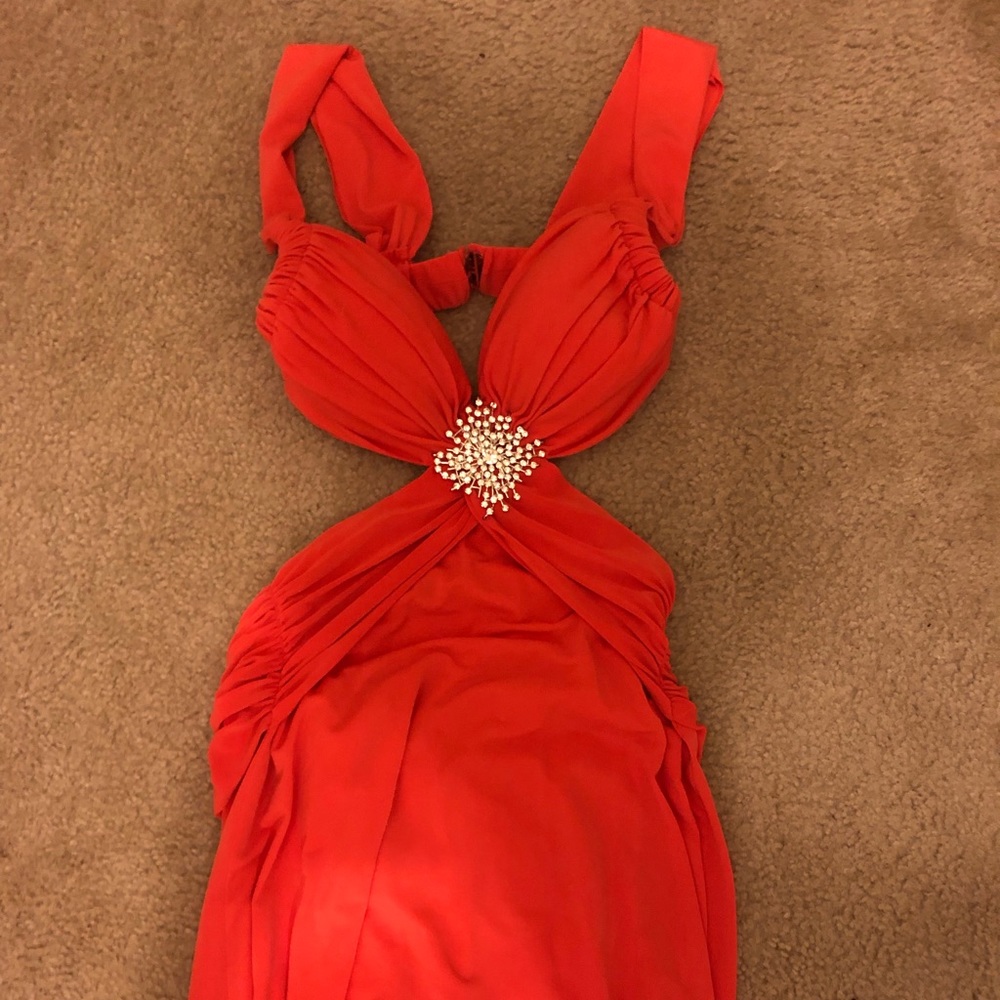 Orange cut out gown with broach